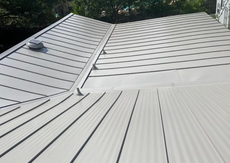 Solar attic fan installed on a metal roof for Roof Ventilation in Lauderdale Lakes