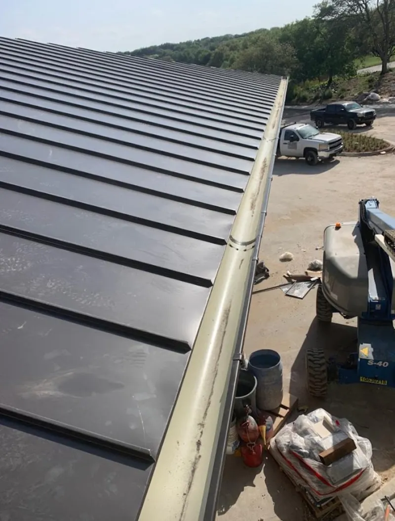 Standing seam panel and gutter detail on a metal roofing jobsite in Lauderdale Lakes